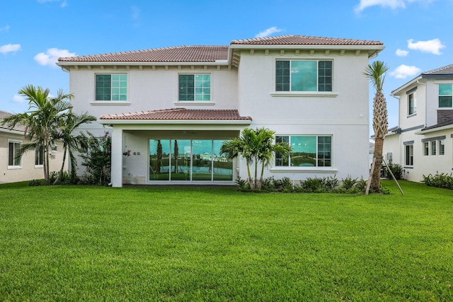 rear view of property with a lawn