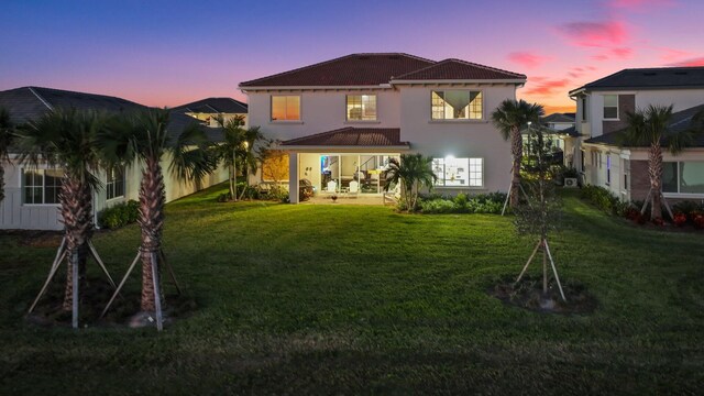 rear view of house with a lawn