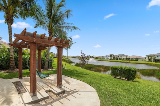 view of patio with a pergola and a water view