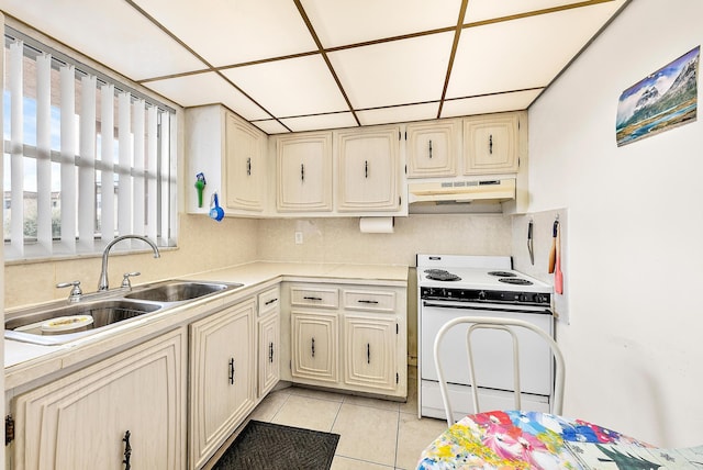 kitchen featuring decorative backsplash, a drop ceiling, sink, white electric range, and light tile patterned flooring