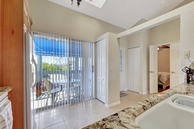 bathroom with tile patterned floors, ceiling fan, lofted ceiling, and sink