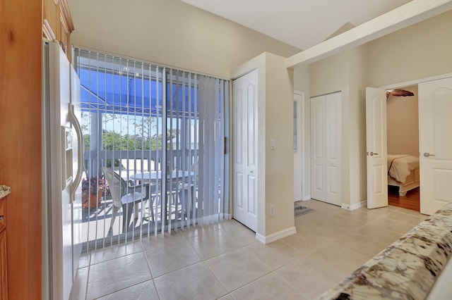 tiled entryway with vaulted ceiling