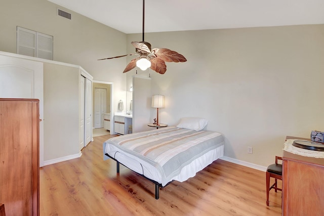 bedroom featuring light wood-type flooring, high vaulted ceiling, ensuite bath, and ceiling fan