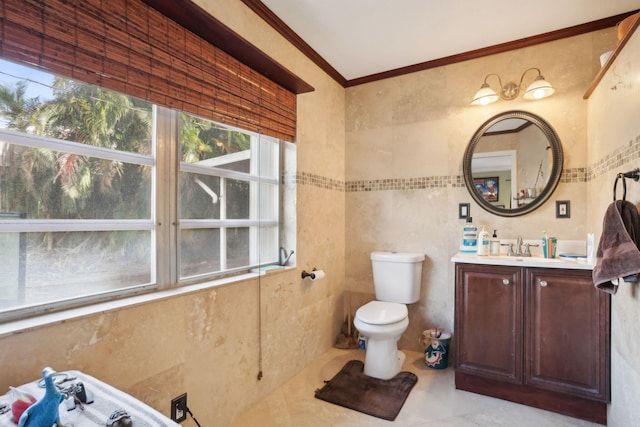 bathroom featuring vanity, crown molding, tile patterned flooring, toilet, and tile walls