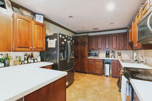 kitchen featuring stainless steel appliances, ornamental molding, and sink