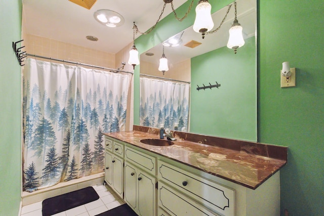 bathroom featuring curtained shower, tile patterned flooring, and vanity