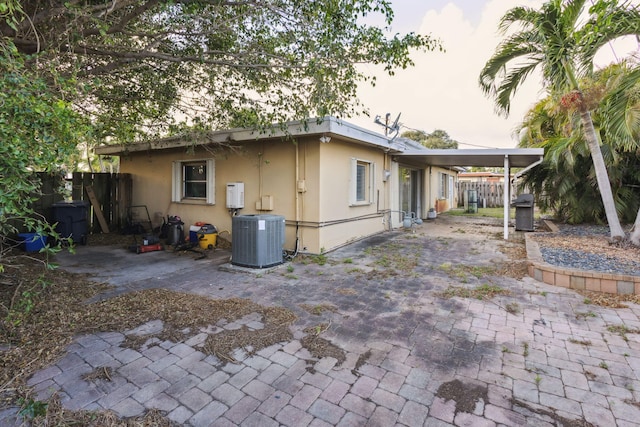 rear view of property featuring central AC