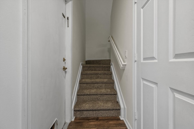 stairs with wood-type flooring