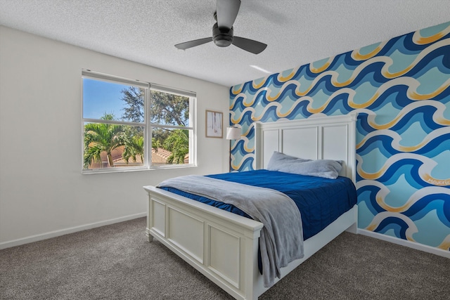 bedroom with ceiling fan, carpet floors, and a textured ceiling