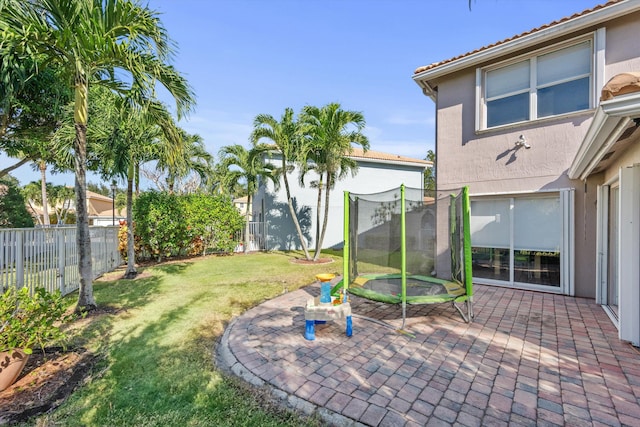 view of yard featuring a patio area and a trampoline