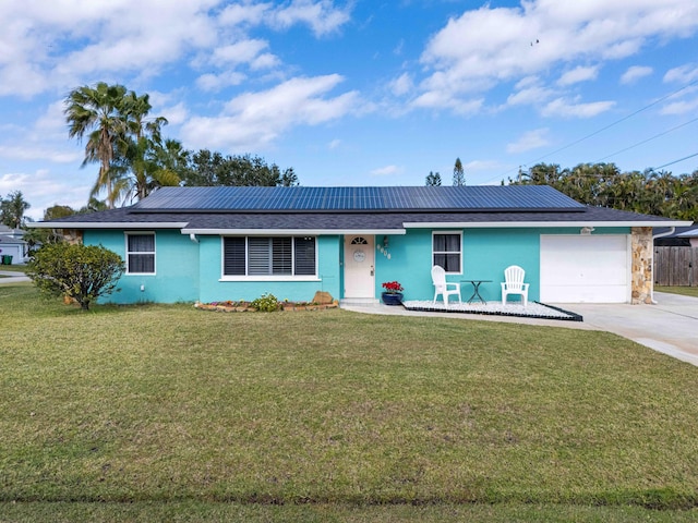 ranch-style house with a front lawn, a garage, and solar panels