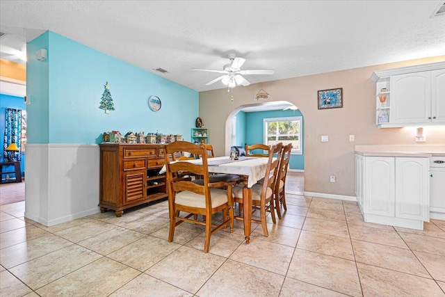 tiled dining area featuring ceiling fan and a textured ceiling