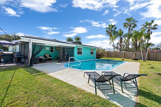 view of swimming pool with a patio and a yard