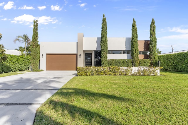 view of front of house with a front yard and a garage