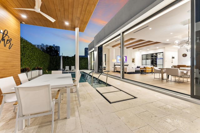 view of pool featuring ceiling fan and a patio area