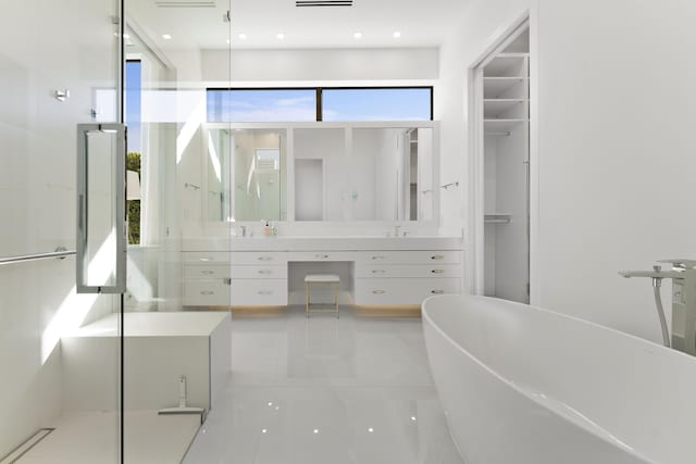 bathroom featuring vanity and shower with separate bathtub