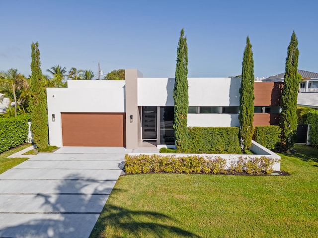 contemporary house with a front yard and a garage