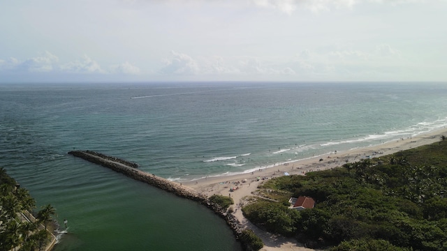 drone / aerial view featuring a beach view and a water view