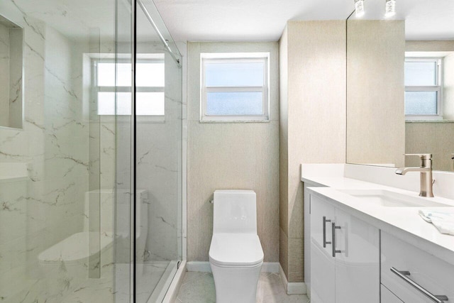 bathroom featuring vanity, toilet, walk in shower, and a wealth of natural light