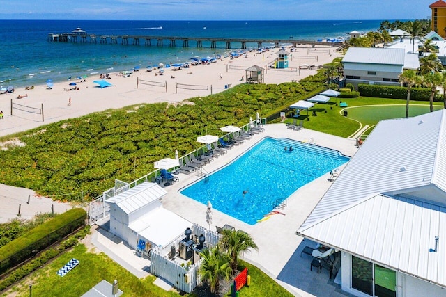 drone / aerial view with a beach view and a water view