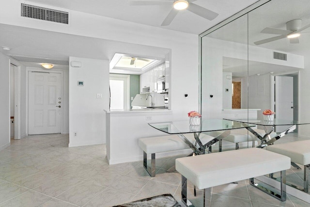 dining room featuring sink and light tile patterned flooring