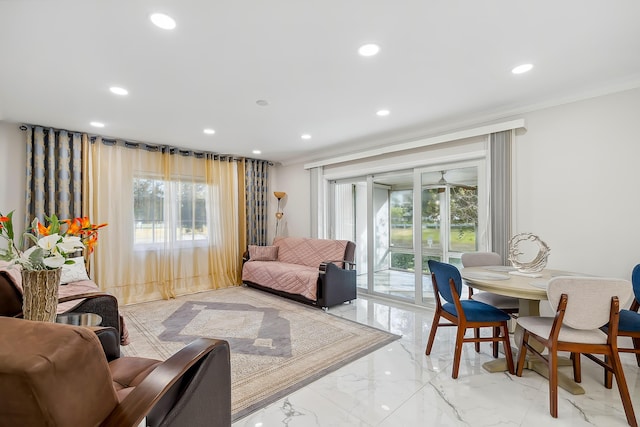 living room with crown molding and a healthy amount of sunlight