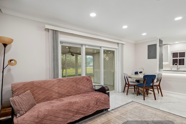 living room with ceiling fan, sink, crown molding, and electric panel