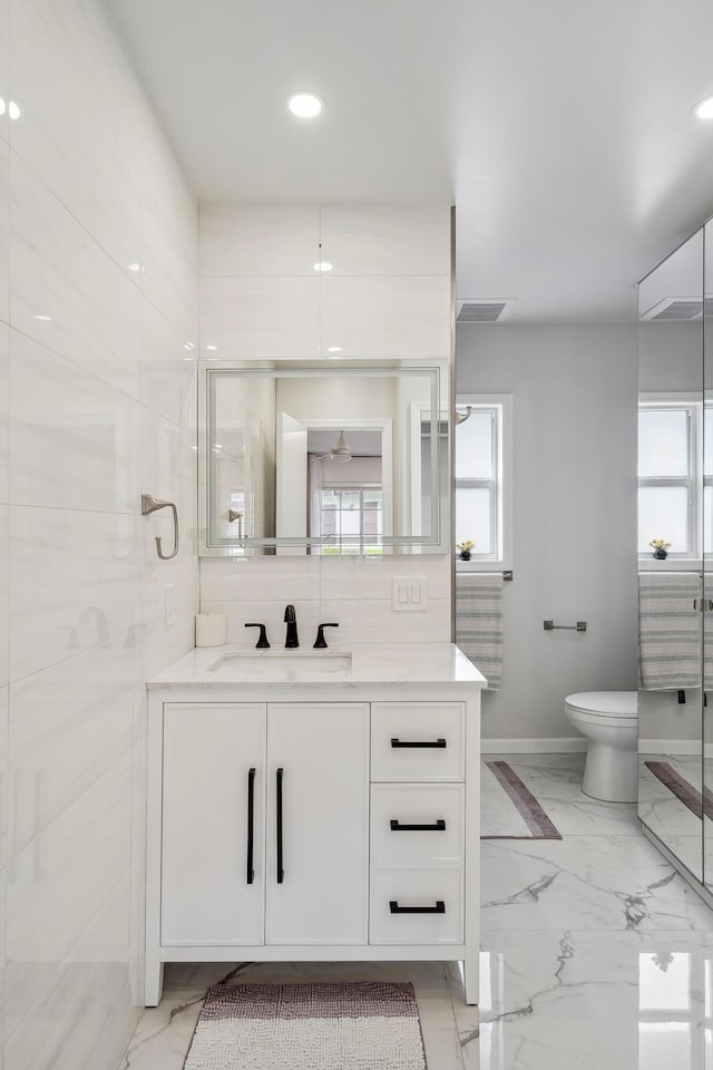 bathroom featuring vanity and toilet