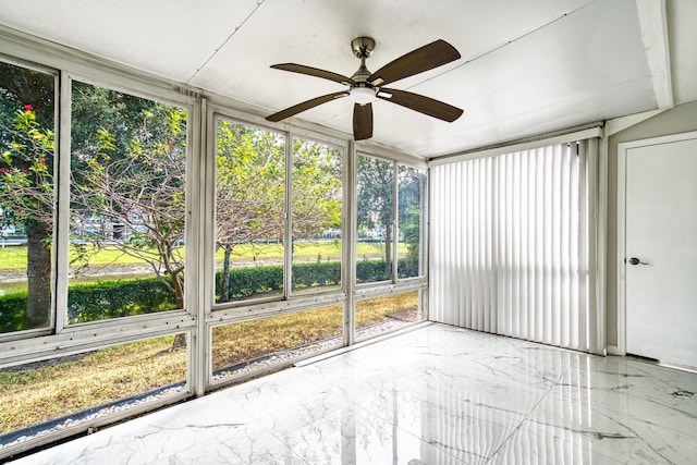 unfurnished sunroom with ceiling fan