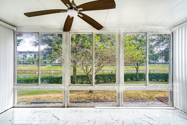 unfurnished sunroom with ceiling fan