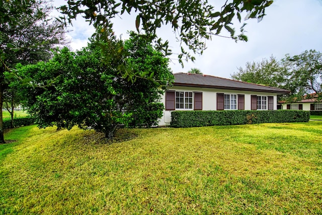 view of property exterior with a yard