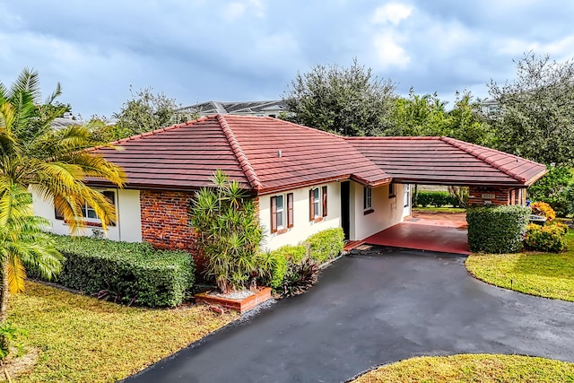 exterior space featuring a front yard and a carport