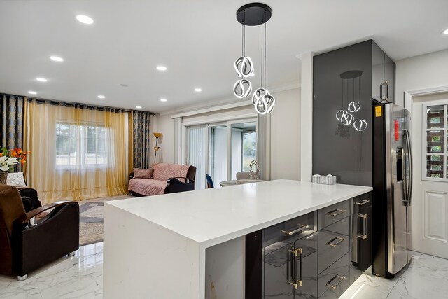 kitchen featuring stainless steel fridge with ice dispenser, gray cabinets, hanging light fixtures, and crown molding