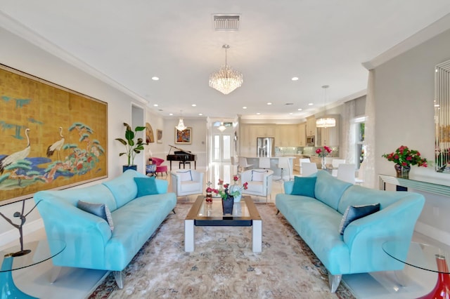 living room with ornamental molding and a chandelier