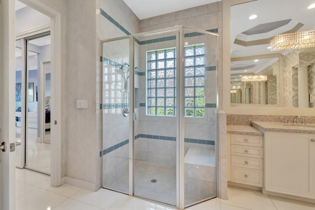 bathroom featuring tile patterned flooring, vanity, and a shower with shower door