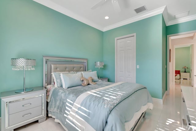 tiled bedroom with ceiling fan, a closet, and ornamental molding