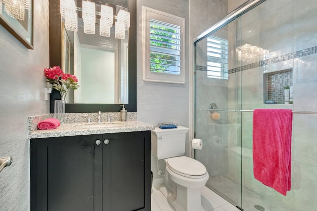 bathroom featuring walk in shower, tile patterned floors, vanity, and toilet