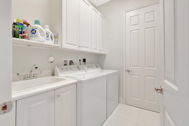 laundry room featuring cabinets, sink, washer and dryer, light tile patterned floors, and ornamental molding