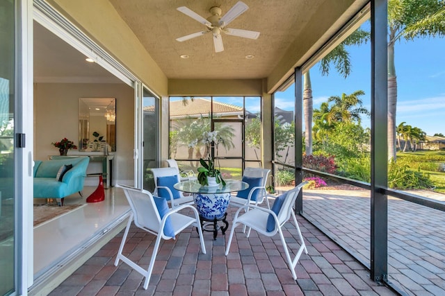 sunroom / solarium featuring ceiling fan