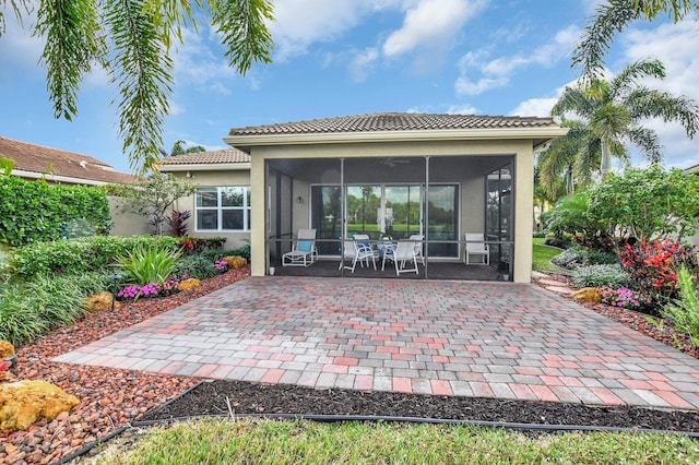 back of house with a sunroom and a patio