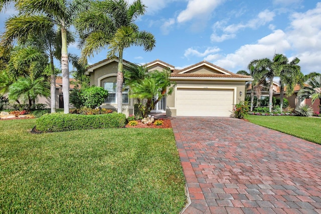 mediterranean / spanish house with a front lawn and a garage