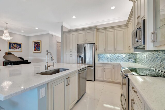 kitchen featuring sink, light stone countertops, stainless steel appliances, and hanging light fixtures