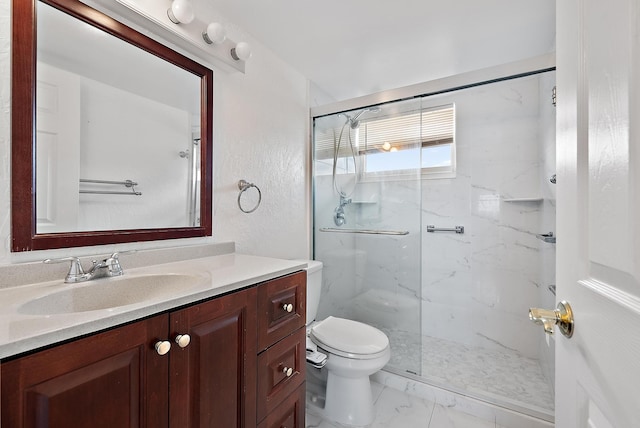 bathroom featuring vanity, an enclosed shower, and toilet