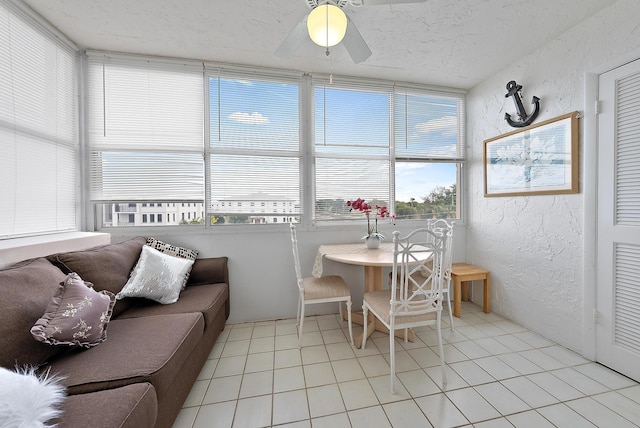 sunroom featuring ceiling fan