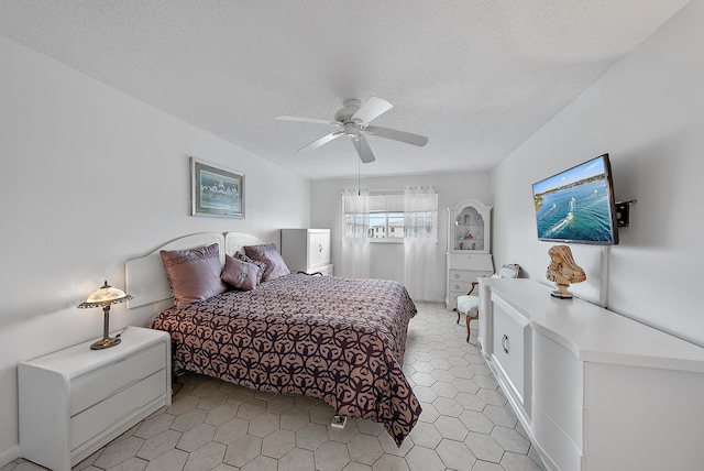 bedroom with a textured ceiling and ceiling fan