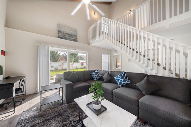 living room featuring wood-type flooring and ceiling fan