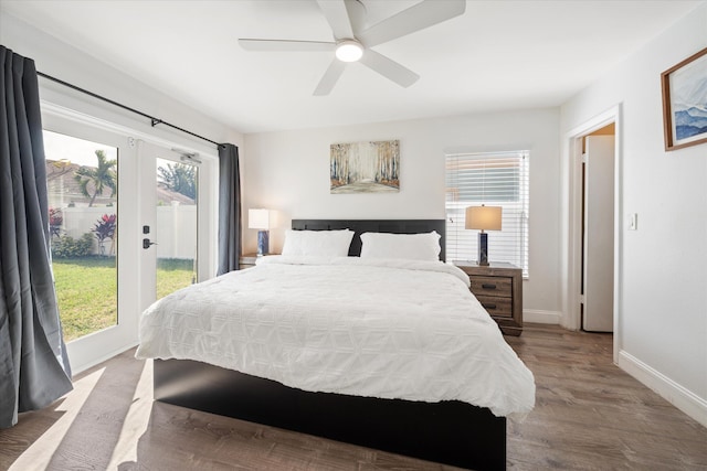 bedroom with hardwood / wood-style flooring, ceiling fan, access to exterior, and multiple windows