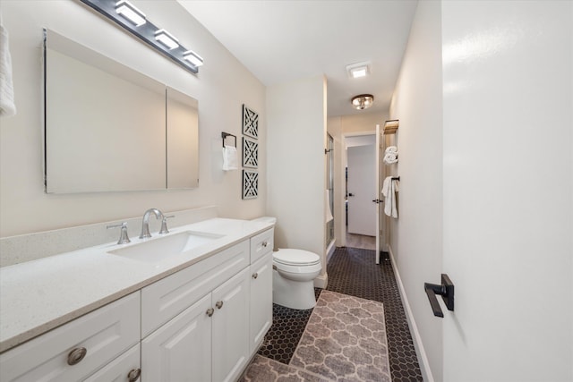 bathroom featuring toilet, walk in shower, and vanity