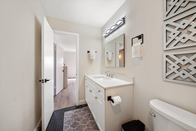 bathroom with toilet and vanity