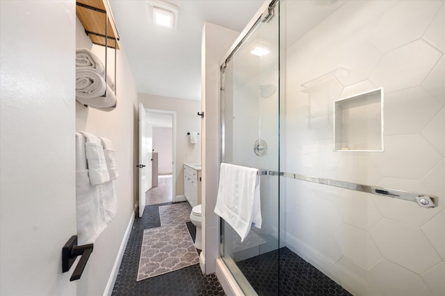 bathroom with walk in shower, vanity, and toilet